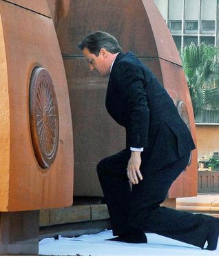 British Prime Minister David Cameron pays his respects at the site of a notorious 1919 massacre of hundreds of Indians by British colonial forces, in Amritsar, India, Wednesday, Feb. 20, 2013